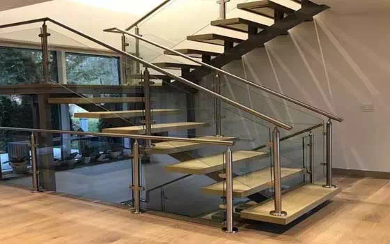 Dual steel stringer open risers with wood stair treads and stainless steel horizontal railing stair